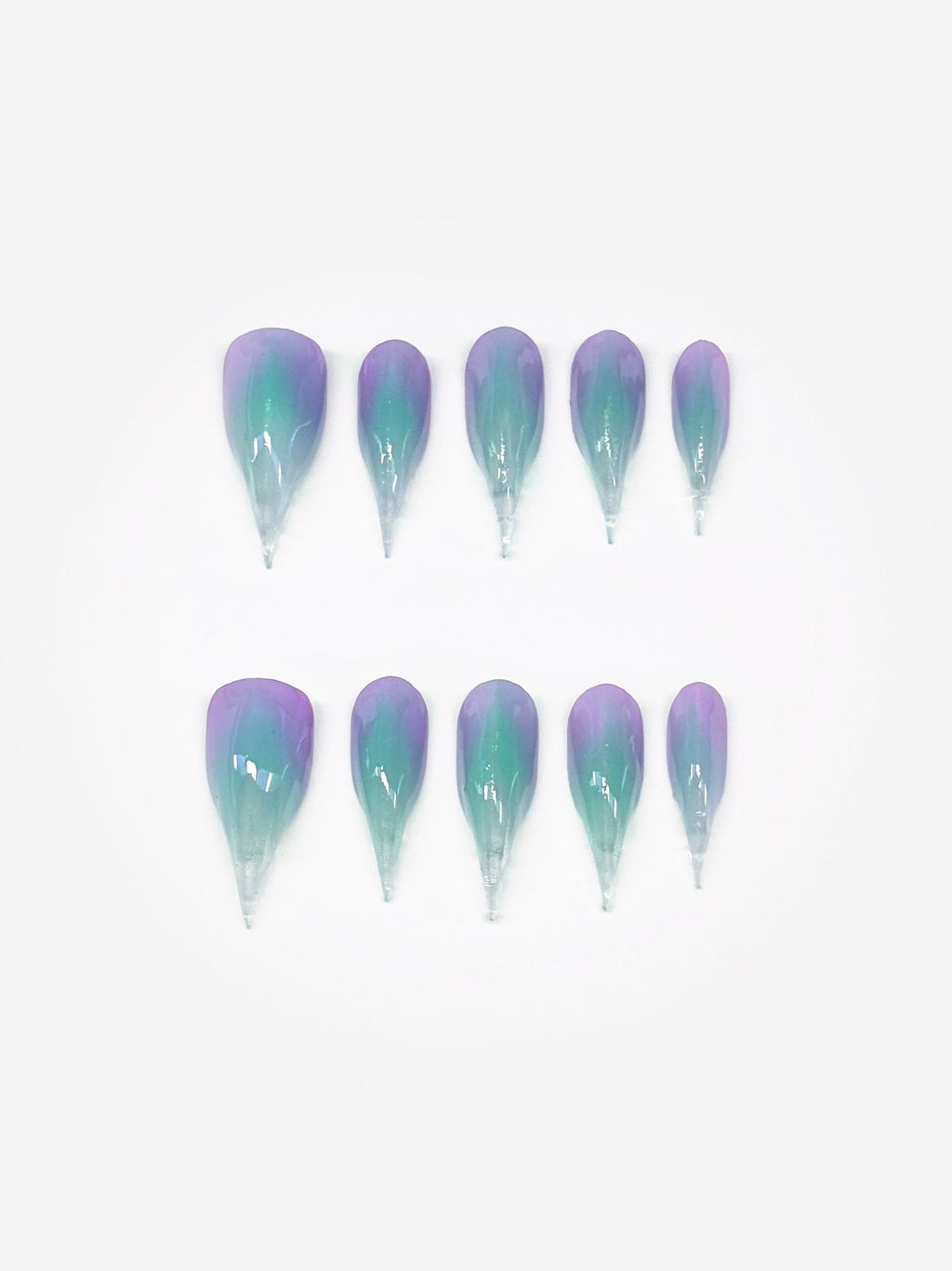 A set of 3D claw art nails, painted in gradient hues of aqua, lavender, and pink. Claw nail set display.
