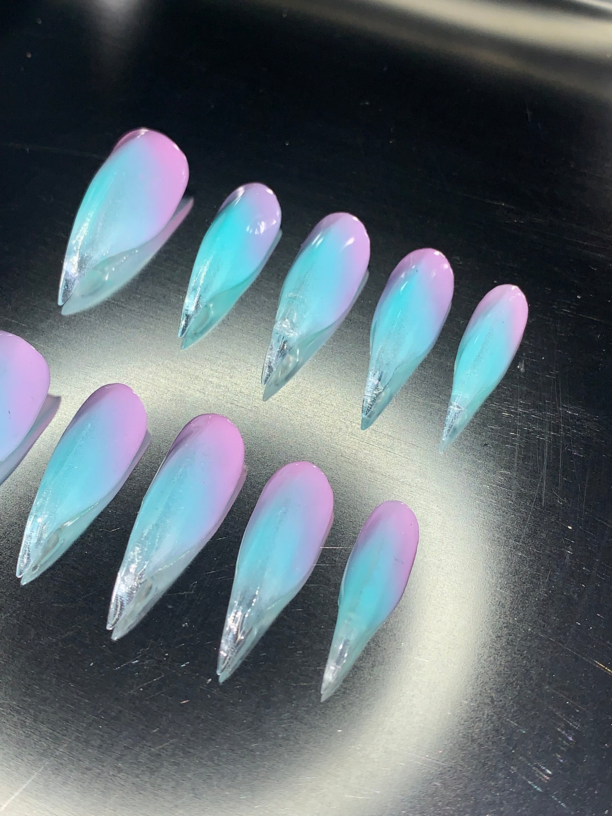 Purple pink to green nails of claw shape